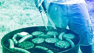 A person grills hamburgers and hot dogs in Arlington, VA, July 2012