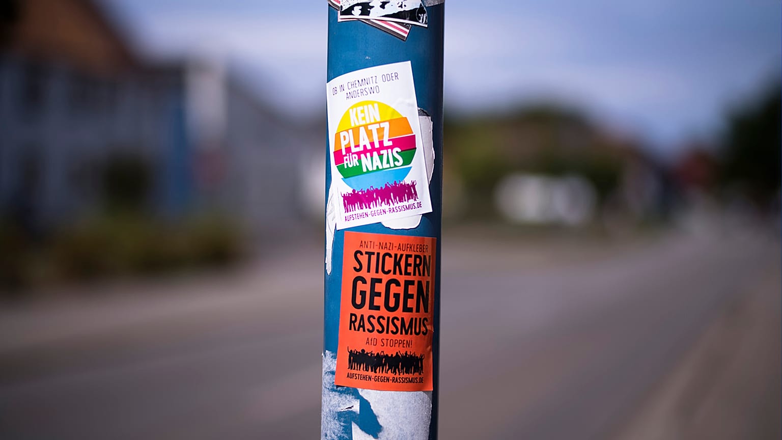 A sticker against Nazis and racism is displayed on a lamp pole near a school in Burg (Spreewald), 18 July 2023