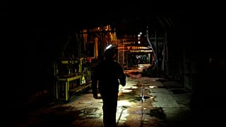 A worker walks along an internal corridor in a damaged DTEK thermal power plant after a Russian attack in Ukraine, Thursday, May 2, 2024.