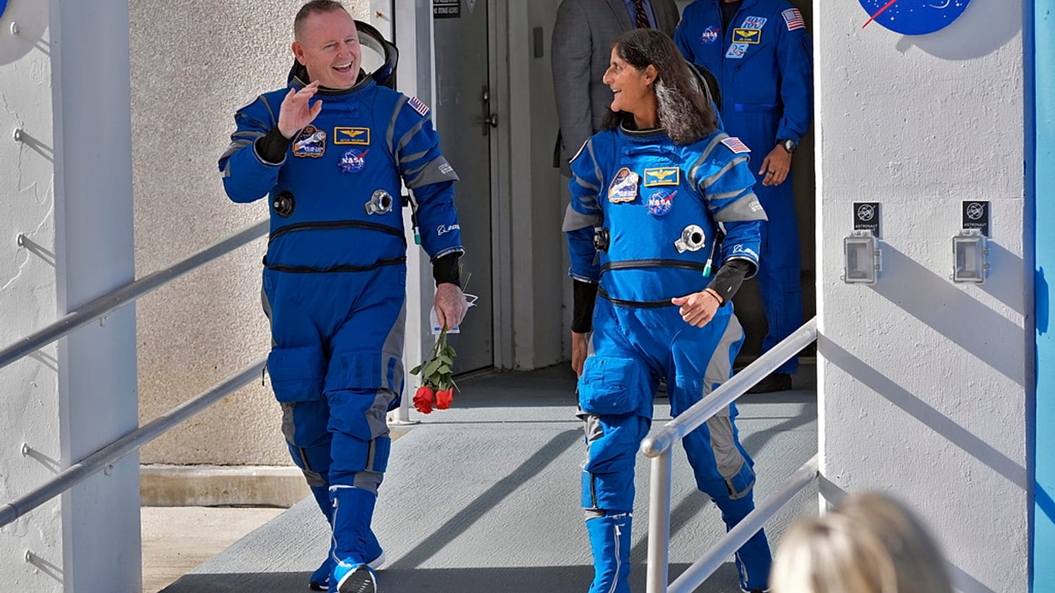 NASA astronauts Butch Wilmore, left, and Suni Williams share a laugh as they leave the building for a trip to launch pad at Space Launch Complex 41 Saturday, June 1, 2024.