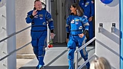 NASA astronauts Butch Wilmore, left, and Suni Williams share a laugh as they leave the building for a trip to launch pad at Space Launch Complex 41 Saturday, June 1, 2024.
