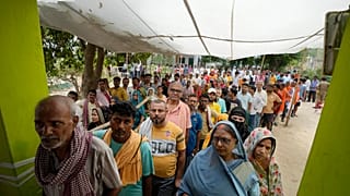People stand in queues to cast their vote in the seventh and final phase of national elections, in Varanasi , India, Saturday, June 1, 2024. 