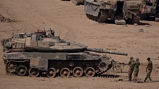 Israeli soldiers work on a tank in a staging area near the Israeli-Gaza border in southern Israel, Monday, June 3, 2024. 
