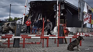 People stand at the scene of buildings damaged by Russian attack in Dnipro, Ukraine, Friday, April 19, 2024. 