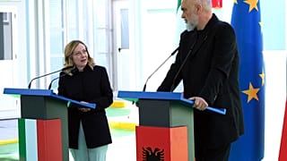 A primeira-ministra italiana Giorgia Meloni com o seu homólogo albanês Edi Rama num centro de acolhimento para migrantes no porto de Shenjin