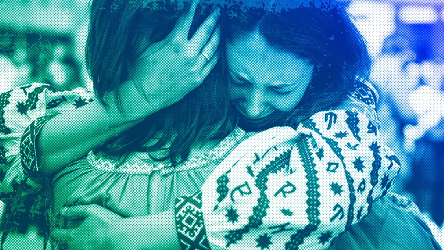 A women hugs the mother of Ukrainian journalist and volunteer combat medic Iryna Tsybukh during a memorial service on Independence square in Kyiv, June 2024
