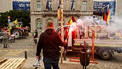 Farmers march with tractors during a protest outside the European Parliament in Brussels, 4 June 2024