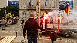 Farmers march with tractors during a protest outside the European Parliament in Brussels, 4 June 2024