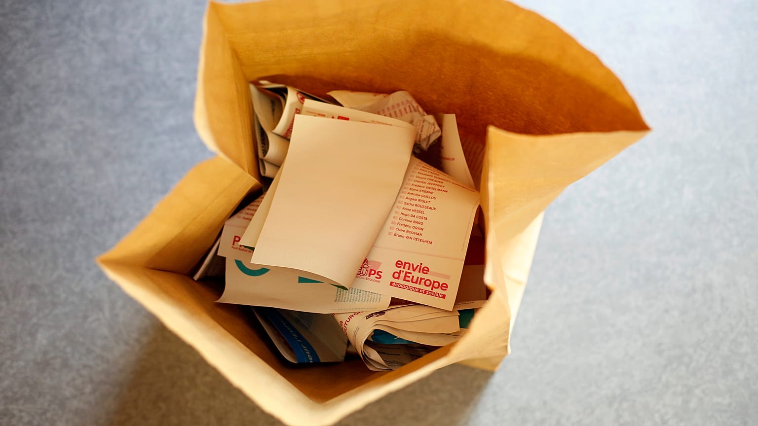 Ballot papers lay in a garbage can in a polling station in Paris, Sunday, May 26, 2019.
