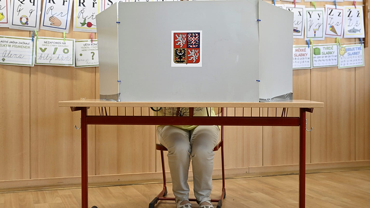 A woman prepares her ballots for the European Parliament elections at a polling station in Prague, Czech Republic, Friday, June 7, 2024.