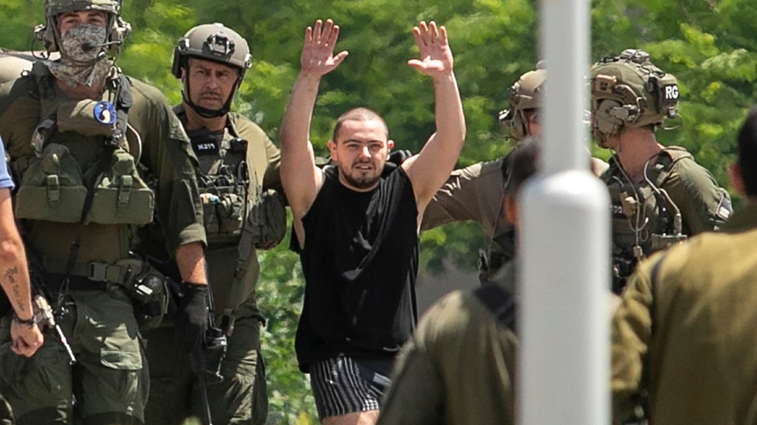 Almog Meir Jan, 21, kidnapped from Israel in a Hamas-led attack on Oct. 7, 2023, raises his hands after arriving by helicopter to the Sheba Medical Center in Ramat Gan, Israel