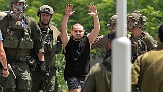 Almog Meir Jan, 21, kidnapped from Israel in a Hamas-led attack on Oct. 7, 2023, raises his hands after arriving by helicopter to the Sheba Medical Center in Ramat Gan, Israel