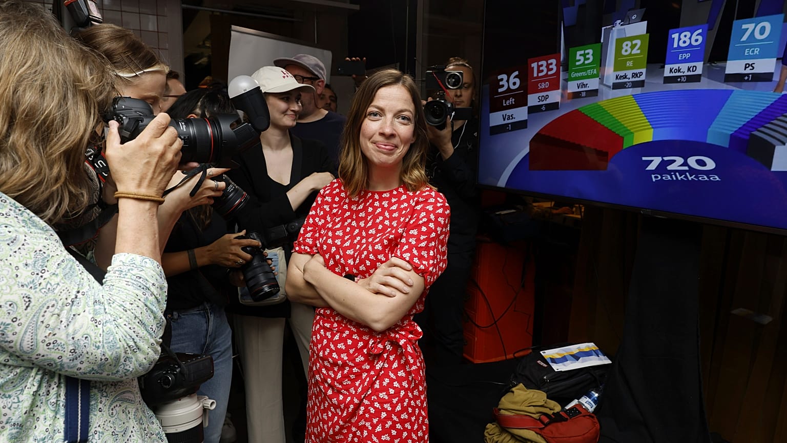 Party leader and election candidate Li Andersson smiles, surrounded by media, at the end of the Left Alliance's European parliament election reception in Helsinki, Finland