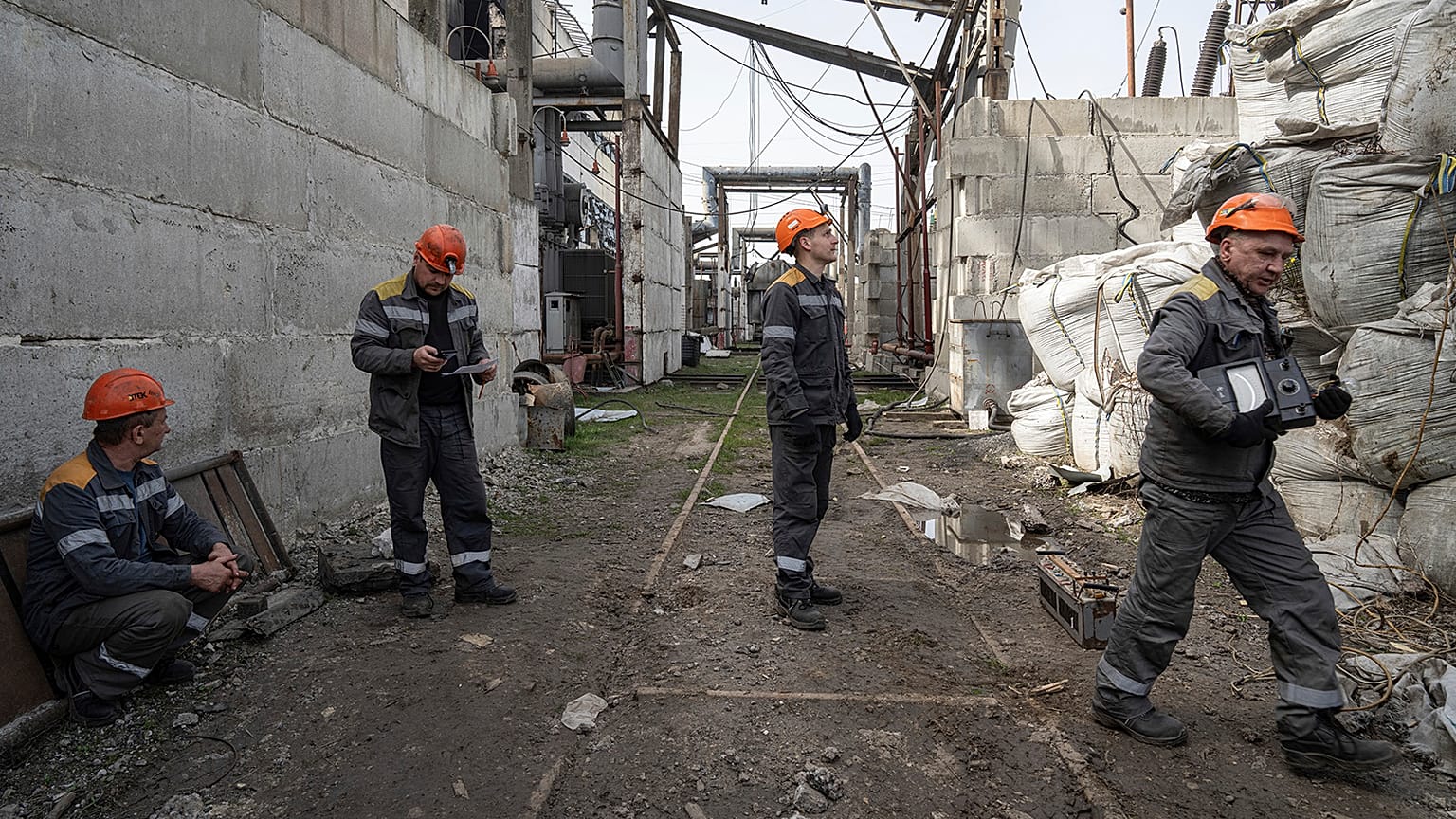Workers check a transformer damaged by a Russian missile attack at DTEK's power plant in Ukraine, 1 April 2024