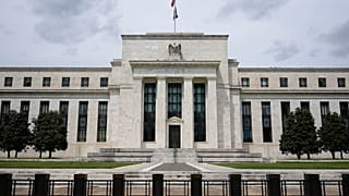 An American flag flies over the Federal Reserve building in Washington