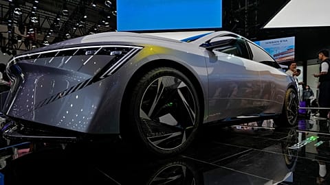 A visitor takes a photo of a Nissan EVO Concept car model on display during the Auto China 2024 in Beijing, Sunday, April 28, 2024. 