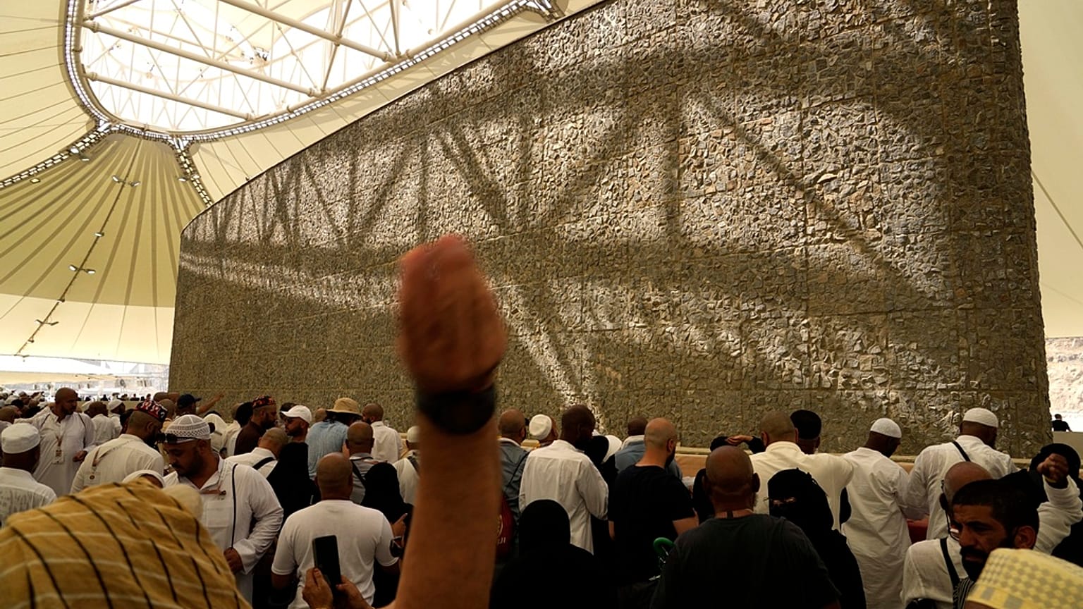 Muslim pilgrims cast stones at pillars in the symbolic stoning of the devil, the last rite of the annual hajj, as it rains in Mina, near the holy city of Mecca, Saudi Arabia.