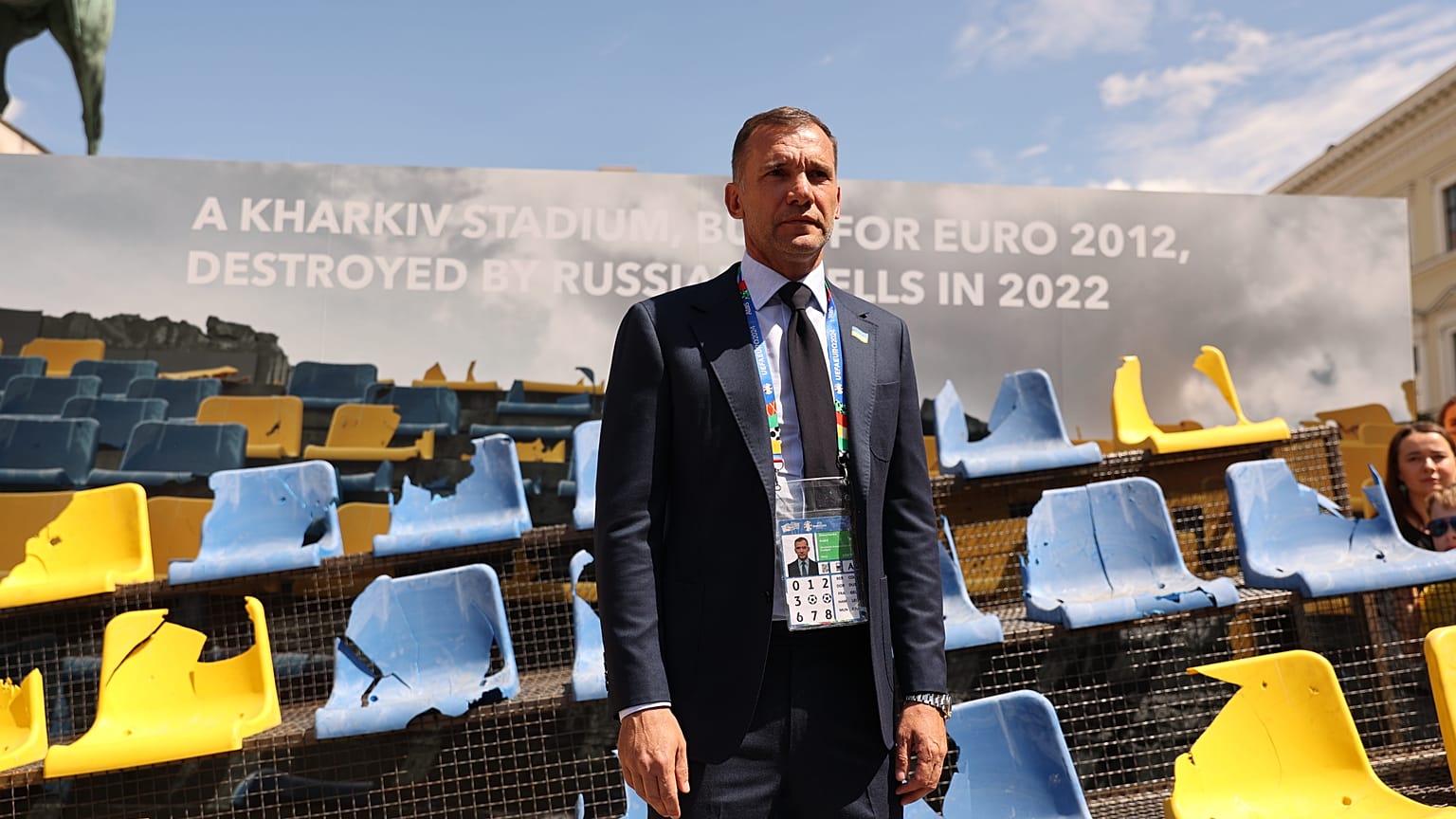 Ukraine Football Association chief Andriy Shevchenko stands in front of the rests of a bombarded Ukrainian football stadium