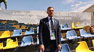 Ukraine Football Association chief Andriy Shevchenko stands in front of the rests of a bombarded Ukrainian football stadium