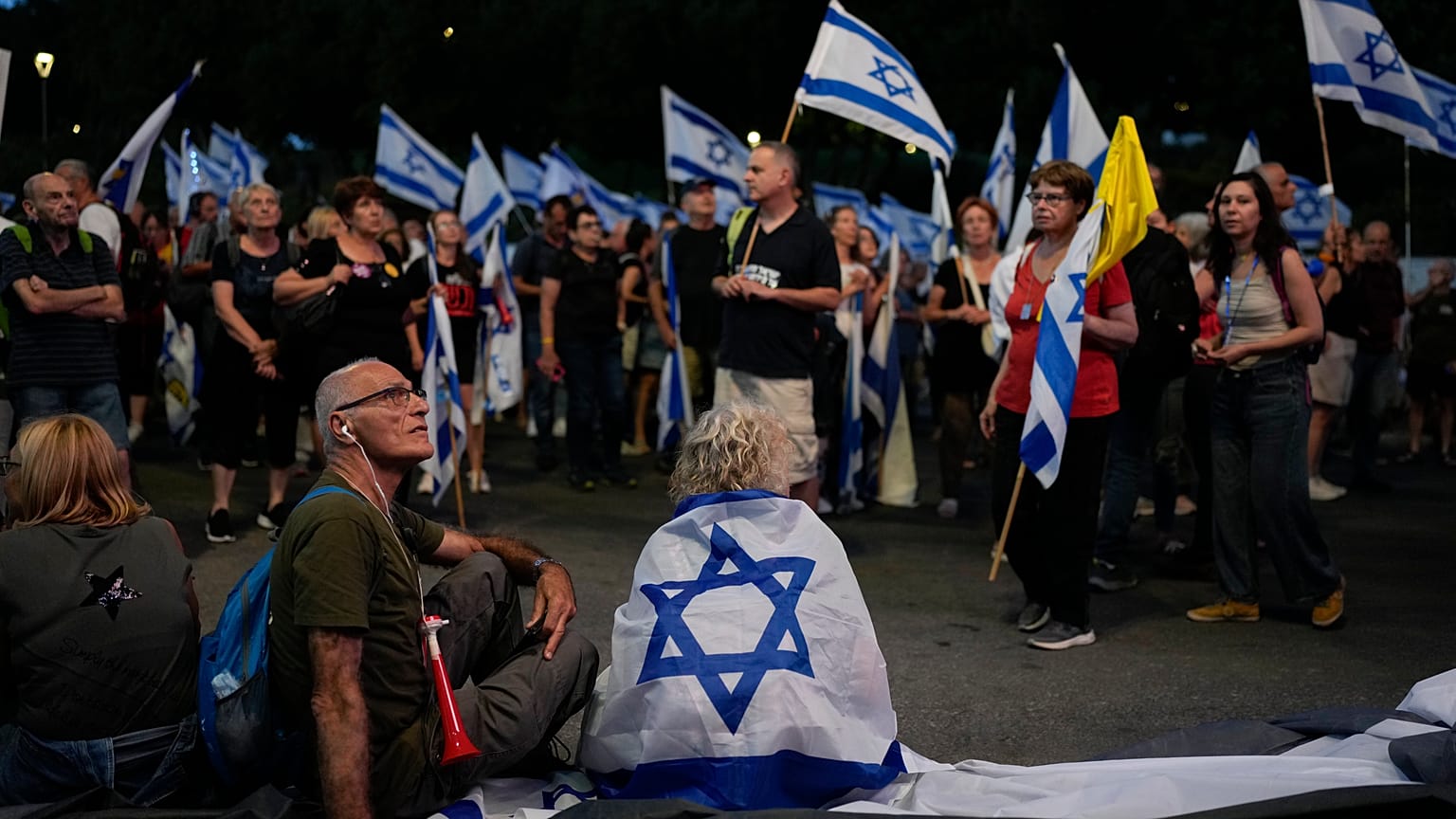People take part in a protest against Israeli Prime Minister Benjamin Netanyahu's government, demanding new elections and the release of the hostages