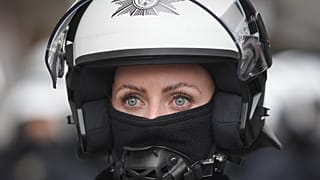 Riot police officer stands guard on the street at the Euro 2024 football tournament in Gelsenkirchen, 16 June 2024