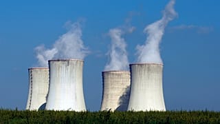 Four of the cooling towers of the Dukovany nuclear power plant rise high above the natural surroundings of Dukovany, Czech Republic.