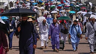 Muslim pilgrims use umbrellas to shield themselves from the sun as they arrive to the last rite of the annual hajj, in Mina, 18 June 2024