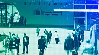 People walk past the European Commission headquarters in Brussels, May 2012