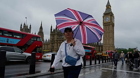 A woman walks outside the Houses of Parliament, in London.