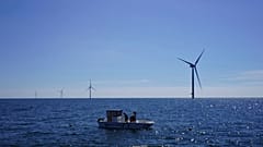 From a boat, workers check seaweed and mussels crops at Kriegers Flak offshore wind farm in the Baltic Sea, Denmark.
