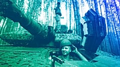 A Ukrainian soldier from 57th brigade looks out from a Swedish Combat Vehicle 90 near front line in Kharkiv region, 18 June 2024