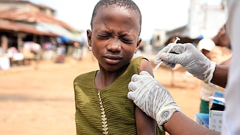 A health worker administers a cervical cancer vaccine HPV Gardasil to a girl on the street in Ibadan, Nigeria.