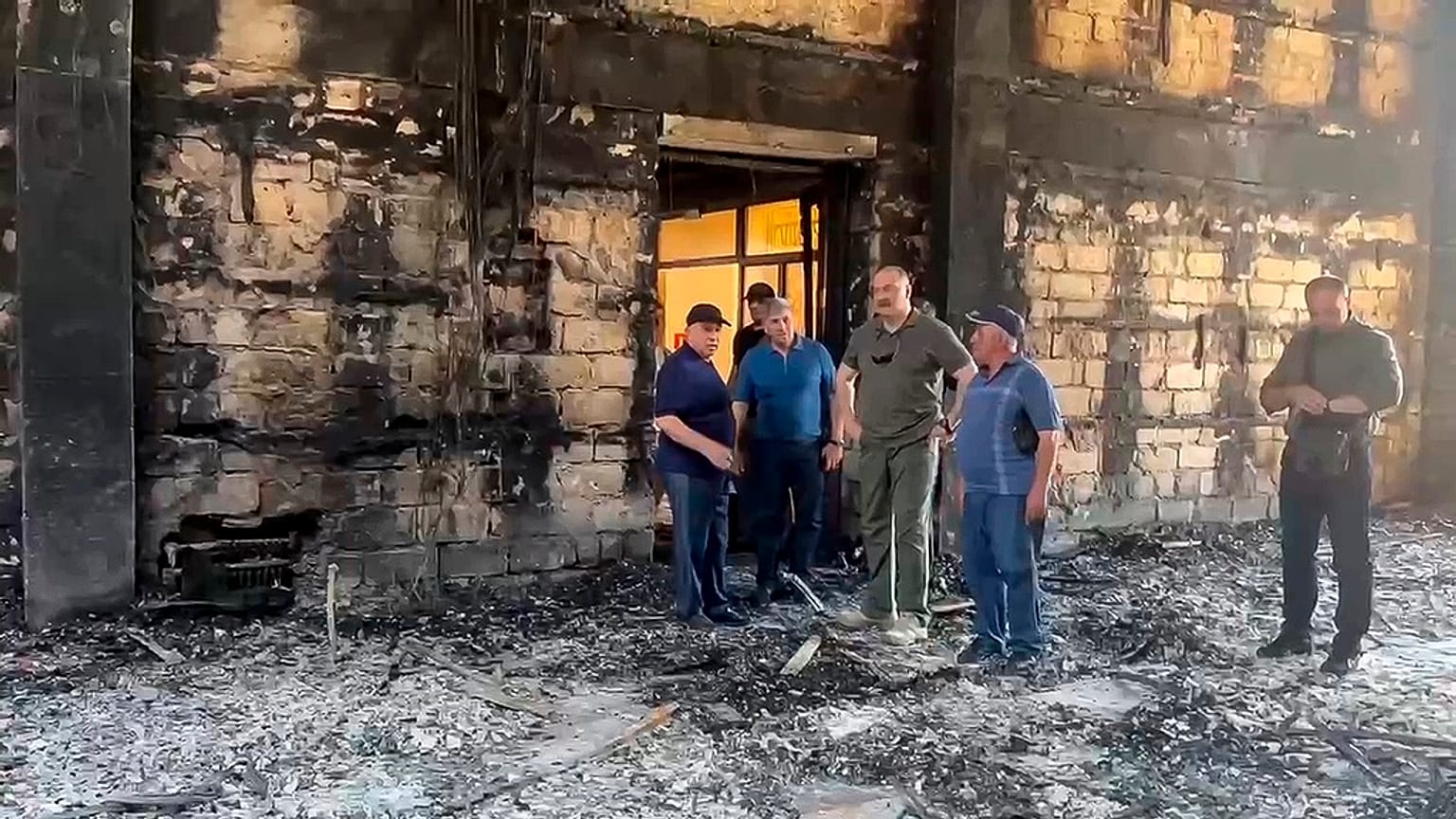 The head of Dagestan Republic Sergei Melikov, center, visits the damaged Kele-Numaz synagogue in Derbent after a counter-terrorist operation in republic of Dagestan, Russia. 