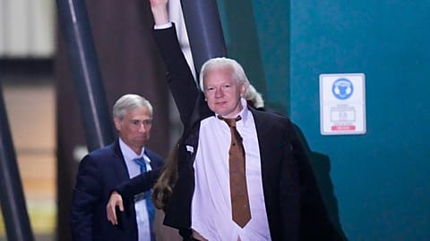 WikiLeaks founder Julian Assange waves after landing at RAAF air base Fairbairn in Canberra, Australia, Wednesday, June 26 2024.