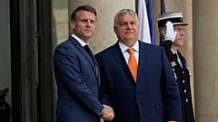 French President Emmanuel Macron, left, shakes hands with Hungarian Preme Minister Viktor Orban before a working lunch.