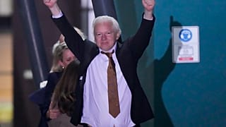 WikiLeaks founder Julian Assange gestures after landing in Canberra, Australia