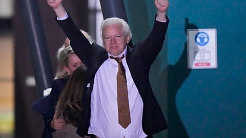 WikiLeaks founder Julian Assange gestures after landing in Canberra, Australia