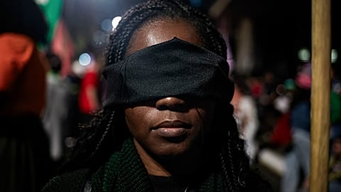 An abortion rights activist with a band over her eyes protests an anti-abortion bill in Congress