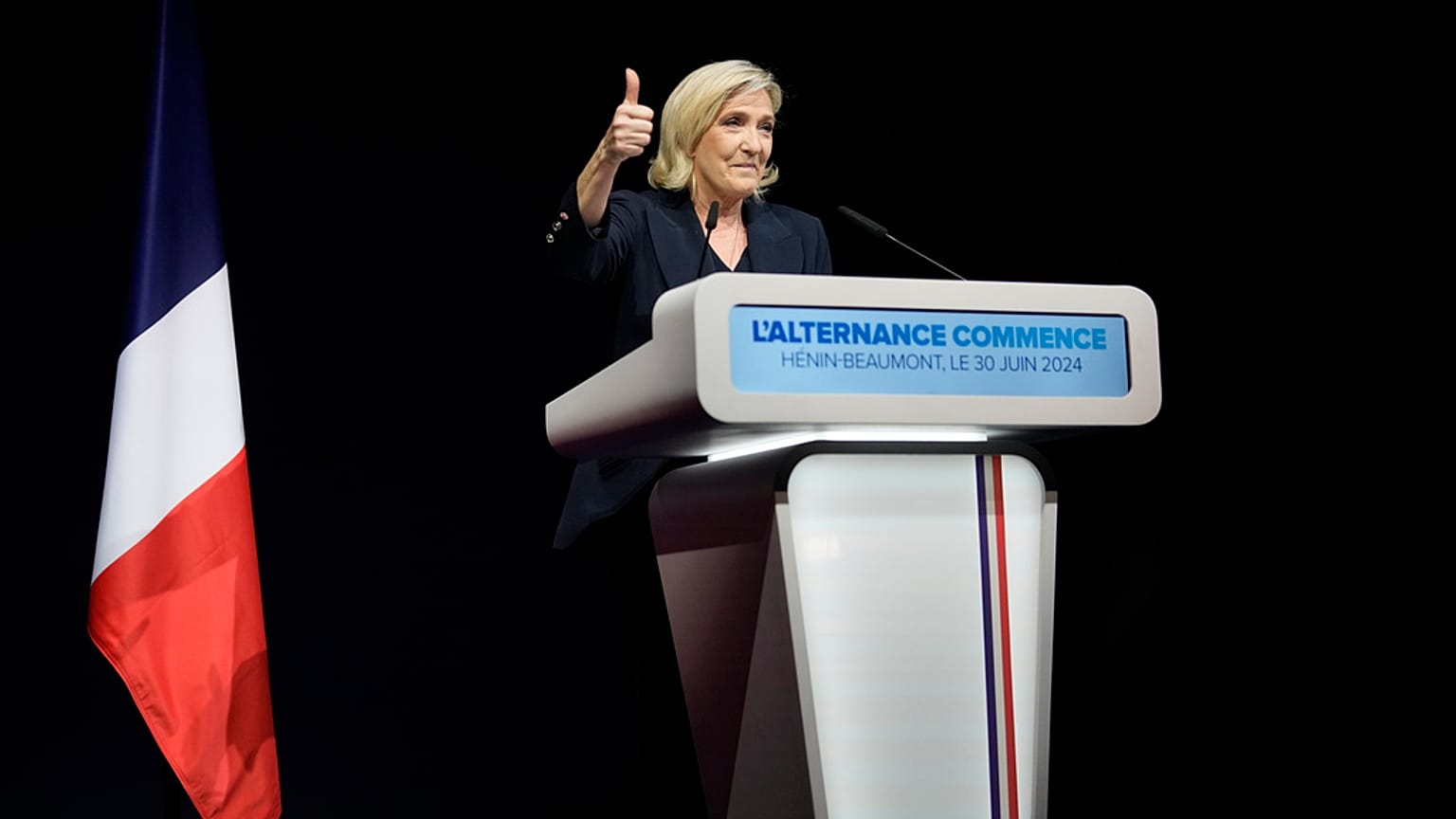 French far right leader Marine Le Pen thumbs up as she delivers her speech after the release of projections based on the actual vote count in select constituencies , Sunday