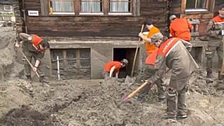 The house is cleared of mud by rescue teams