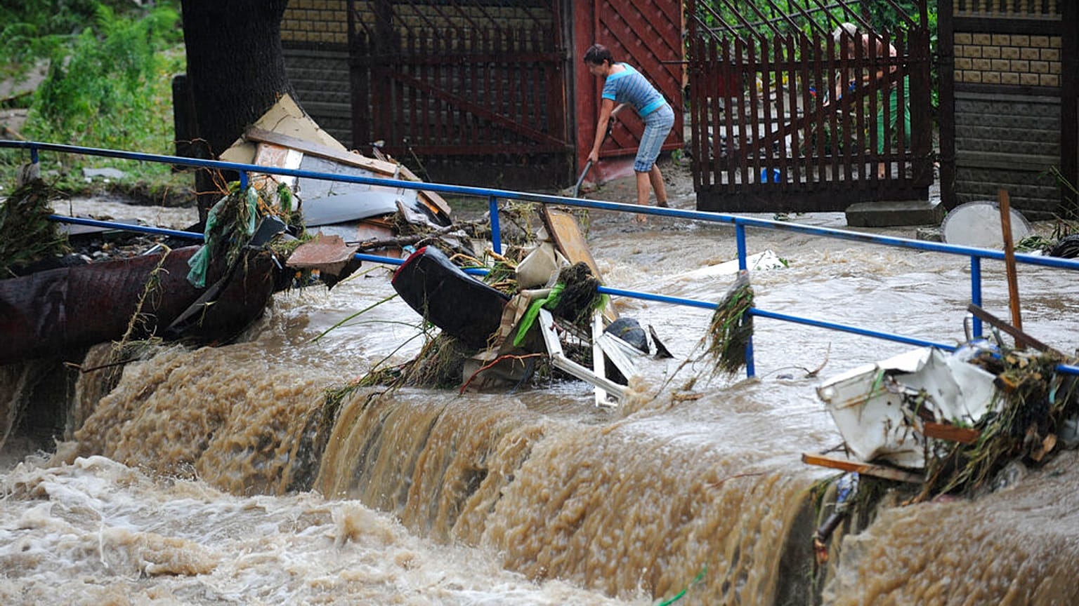 Moradores caminham entre os escombros após as inundações em Bogatynia, Polónia, no sábado, 7 de agosto de 2010. 