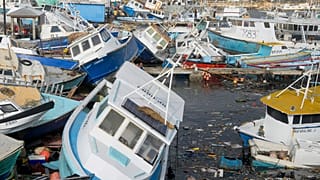 Fishing vessels damaged by Hurricane Beryl sit upended at the Bridgetown Fisheries in Barbados.