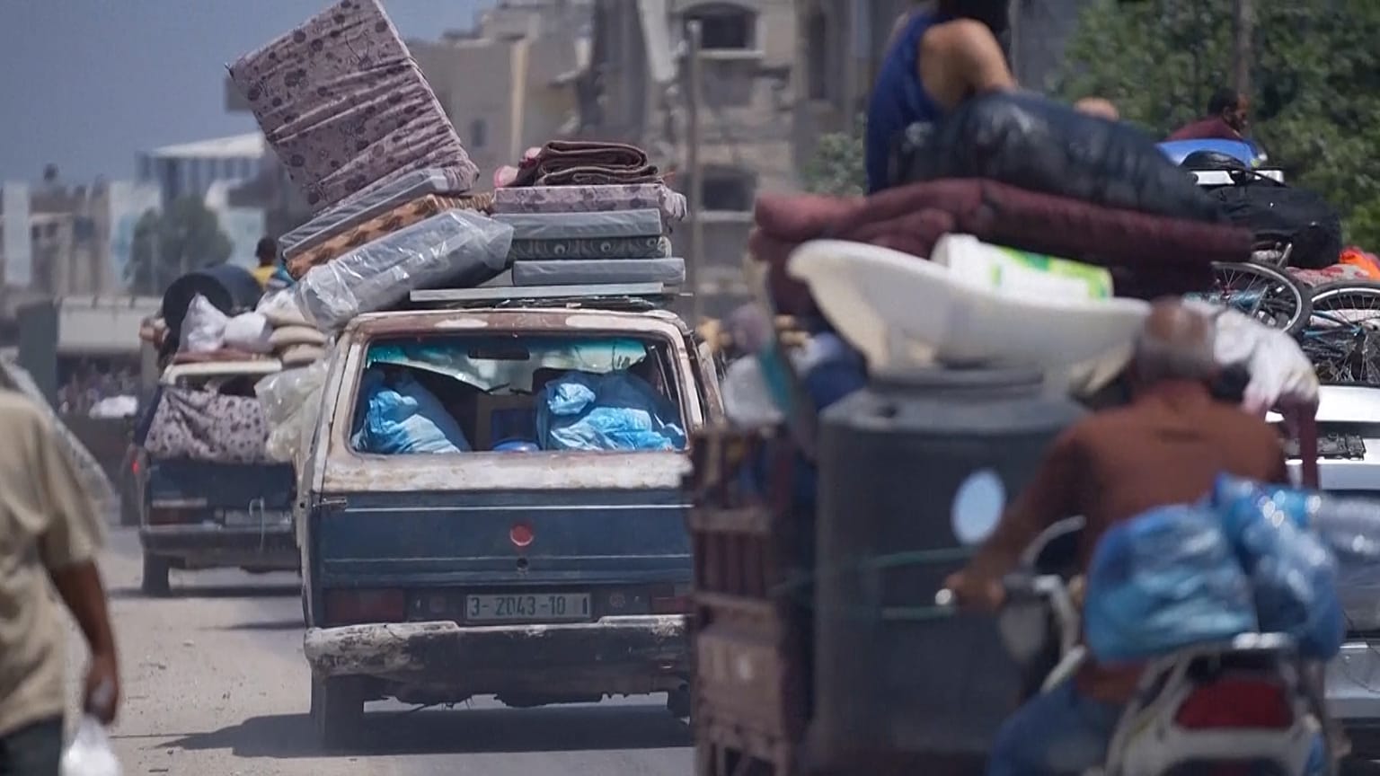 Various of vehicle carrying people's belongings as they evacuate