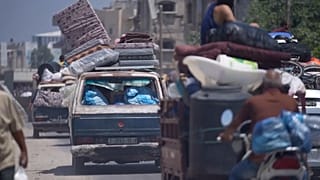 Various of vehicle carrying people's belongings as they evacuate
