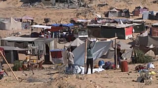 Displaced people building tent