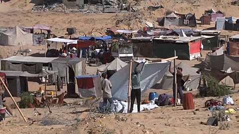 Displaced people building tent
