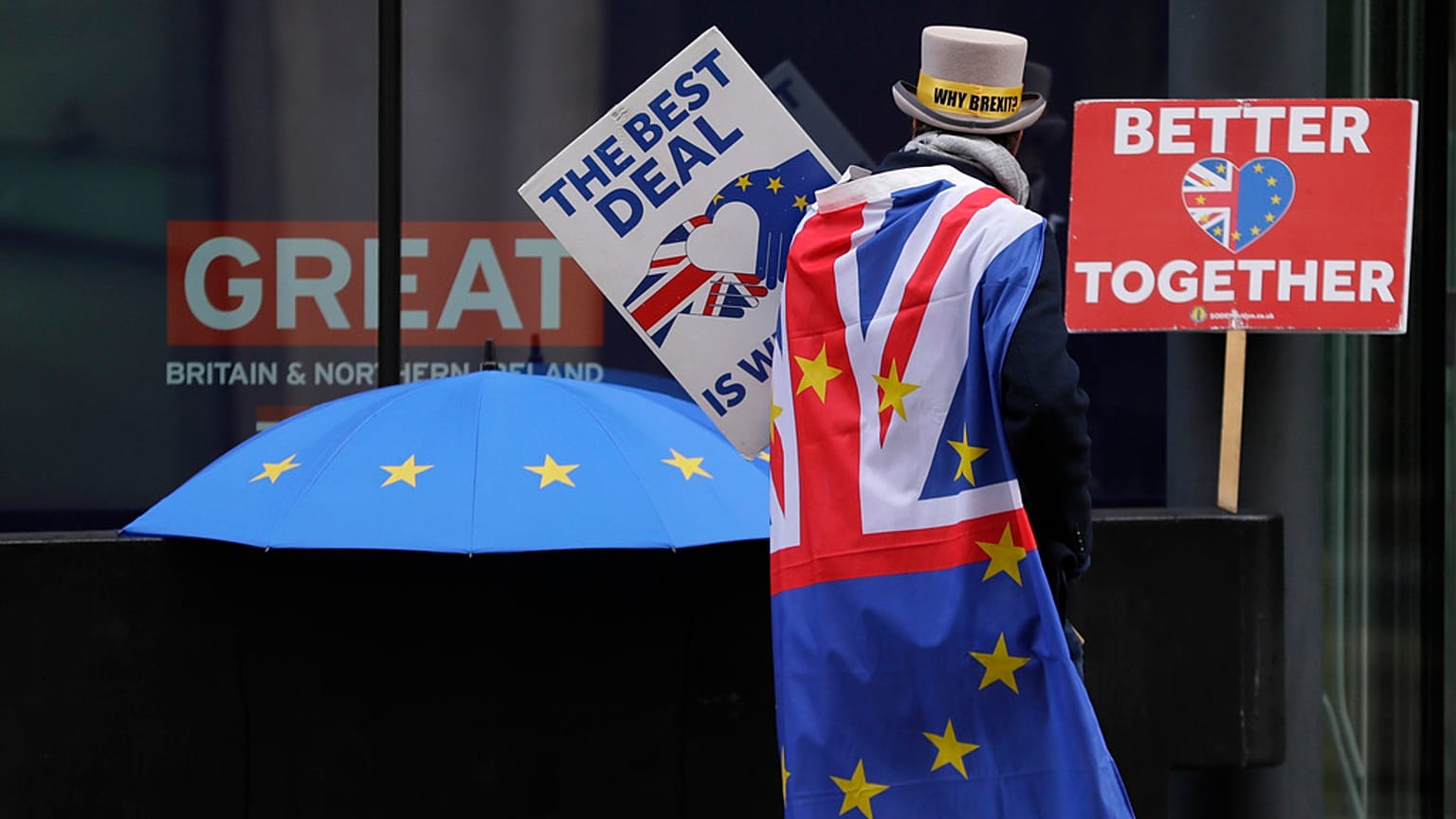 Pro-EU demonstrator Steve Bray props banners outside the conference centre in Westminster where trade talks between the UK and the EU continue in London, Friday, Dec. 4, 2020 