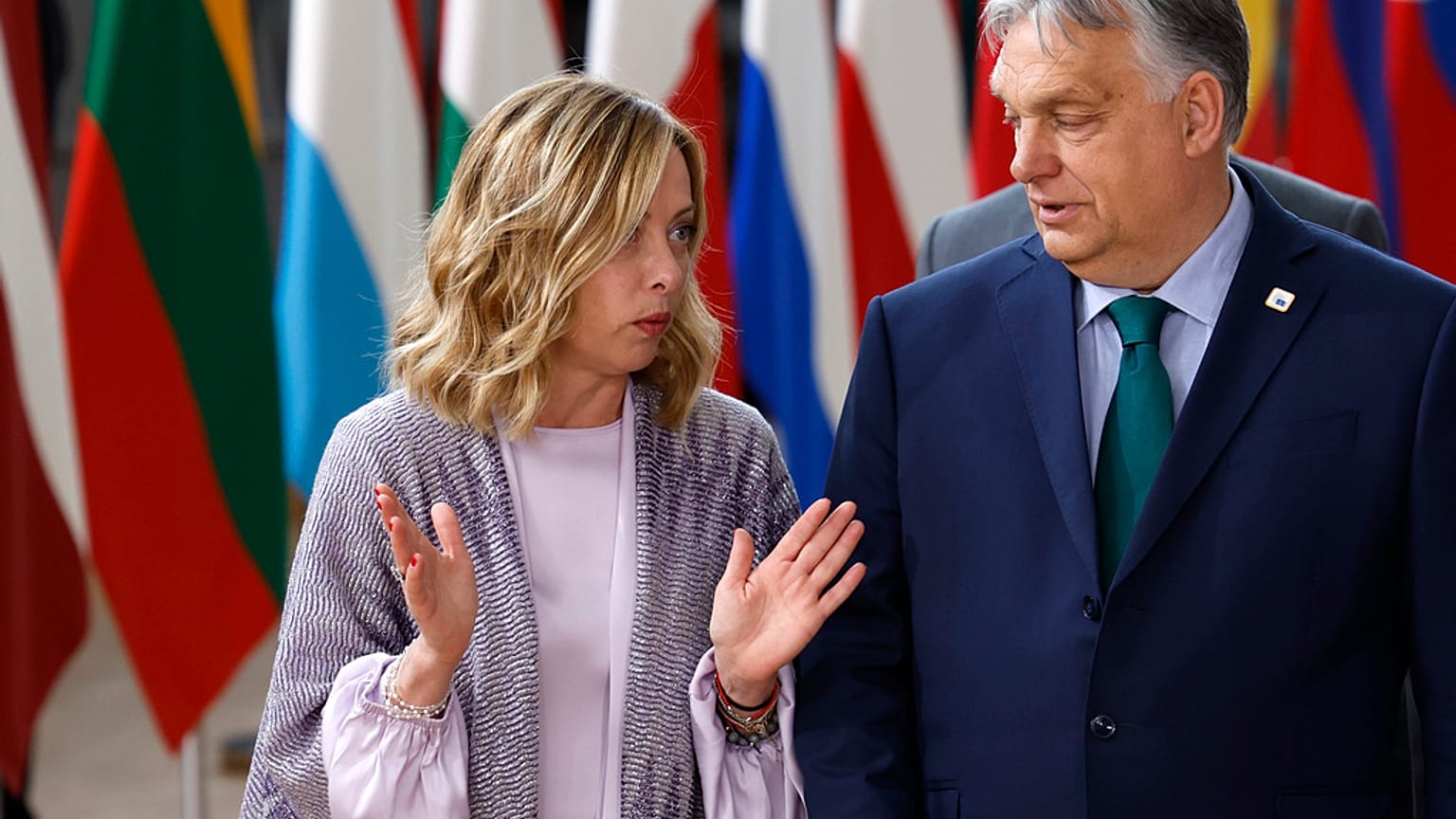 Hungary's Prime Minister Viktor Orban, right, speaks with Italy's Prime Minister Giorgia Meloni prior to a group photo at an EU summit in Brussels, Thursday, June 27, 2024.