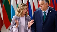 Hungary's Prime Minister Viktor Orban, right, speaks with Italy's Prime Minister Giorgia Meloni prior to a group photo at an EU summit in Brussels, Thursday, June 27, 2024.
