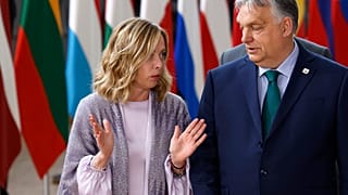 Hungary's Prime Minister Viktor Orban, right, speaks with Italy's Prime Minister Giorgia Meloni prior to a group photo at an EU summit in Brussels, Thursday, June 27, 2024.